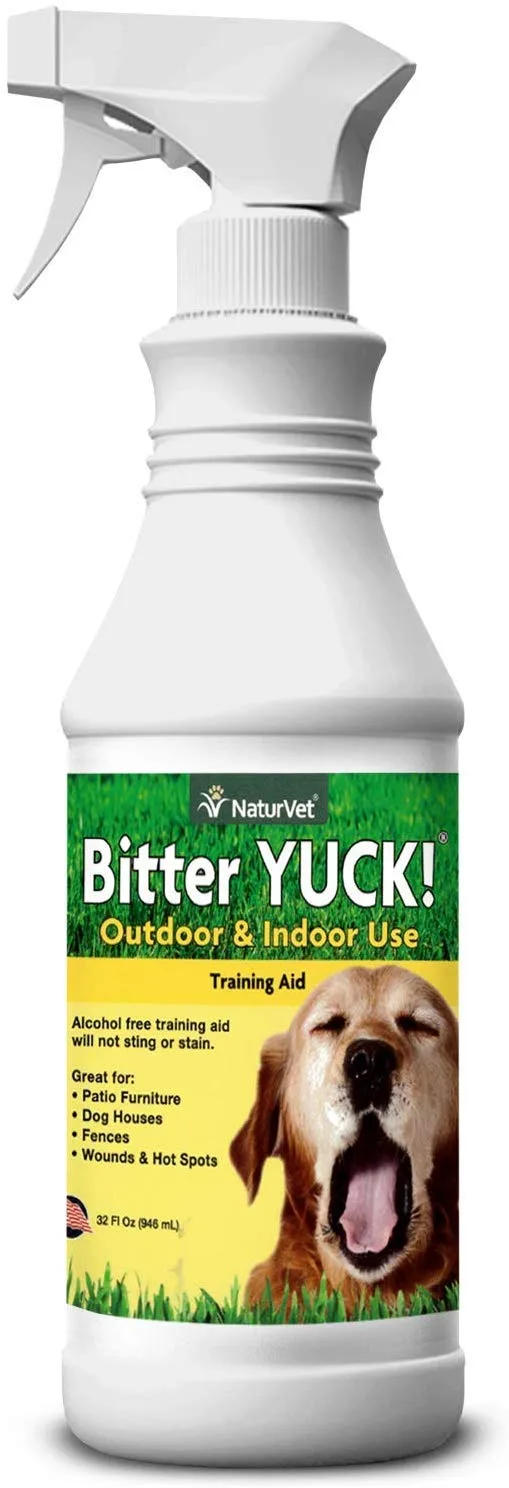 A bottle of Naturvet Bitter Yuck No Chew Spray sitting in front of a decorated Christmas tree
